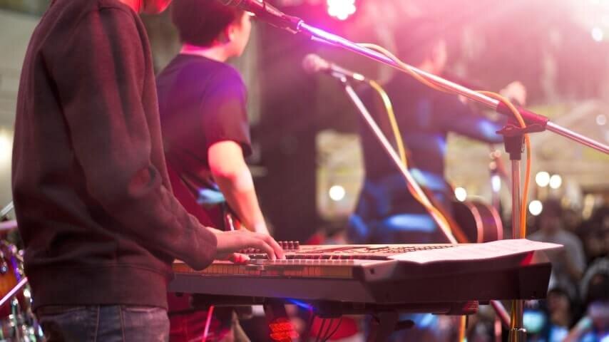 A band on the stage playing a fundraising concert.
