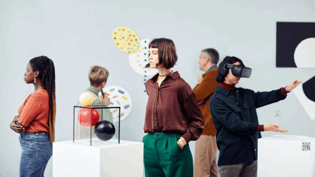 Several people are standing in an art gallery, looking at the exhibitions.