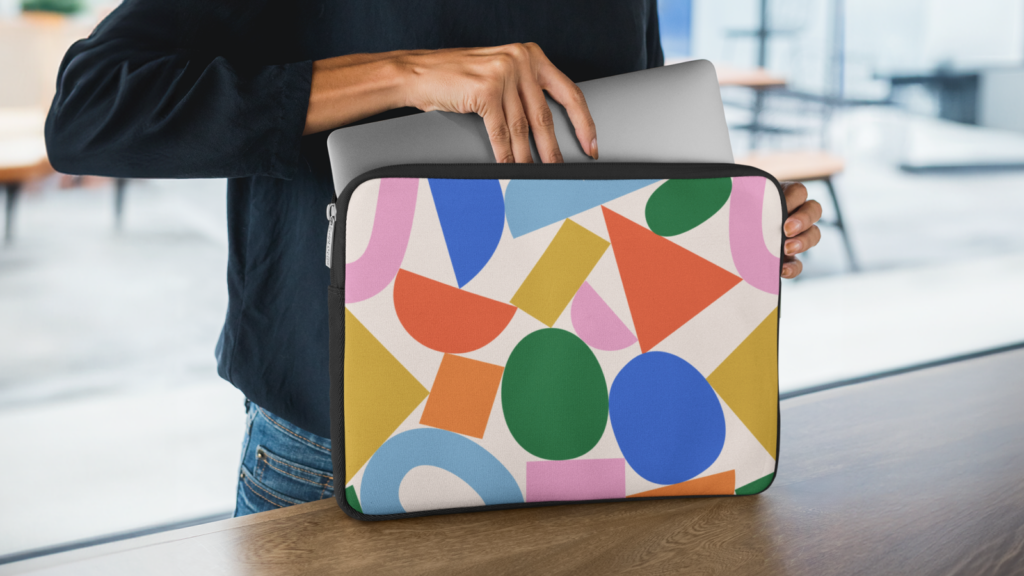 A person putting a laptop in a custom laptop cover.