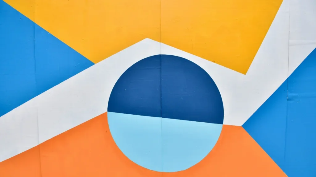 A vibrant wall featuring a design in blue, orange, and yellow colors, creating an eye-catching visual display.