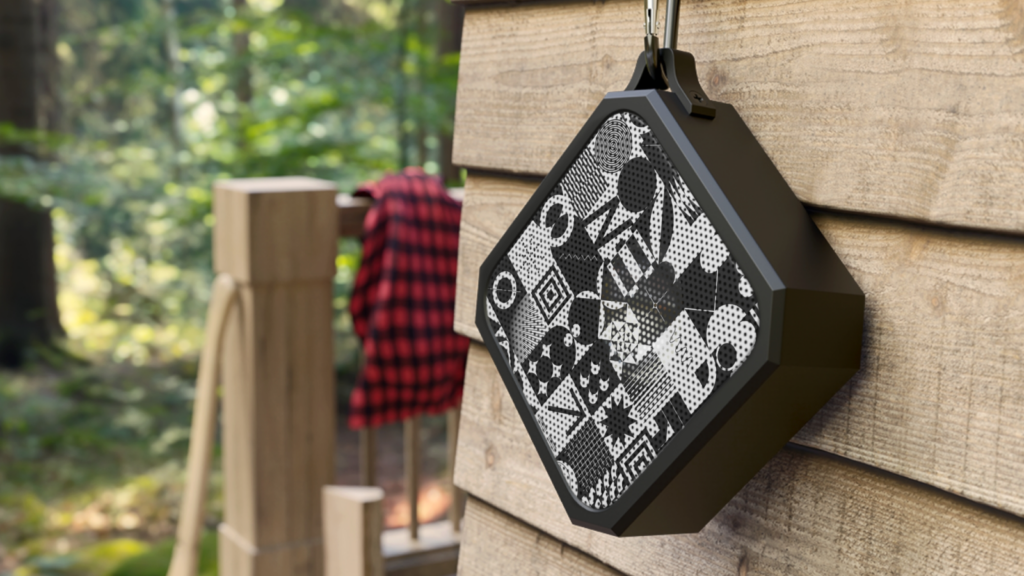 Custom Bluetooth speaker hanging from a wooden wall.