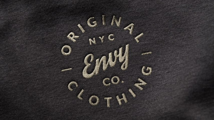 Embroidered logo on a black fabric.