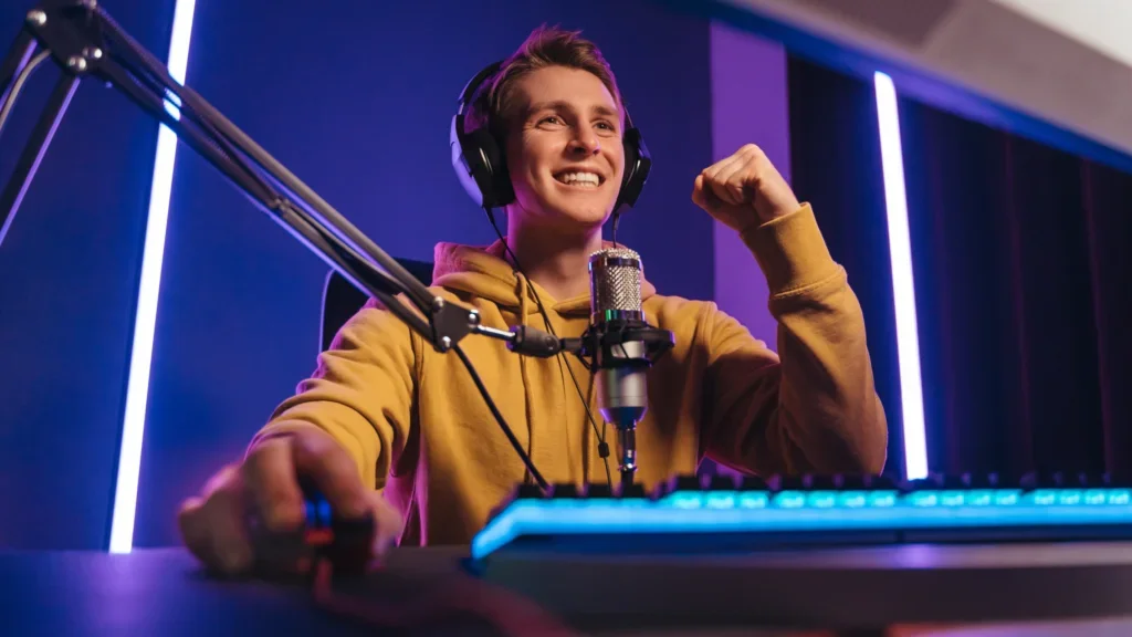 An affiliate marketer wearing headphones speaks into a microphone in a professional studio setting and creates content for affiliate projects.