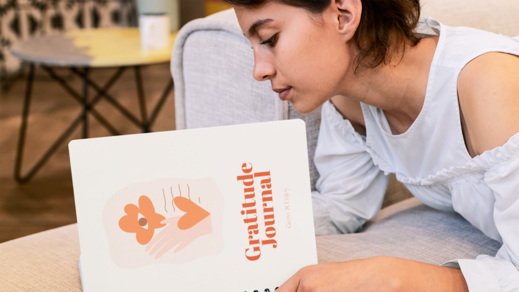 A woman reading a custom-printed gratitude journal.