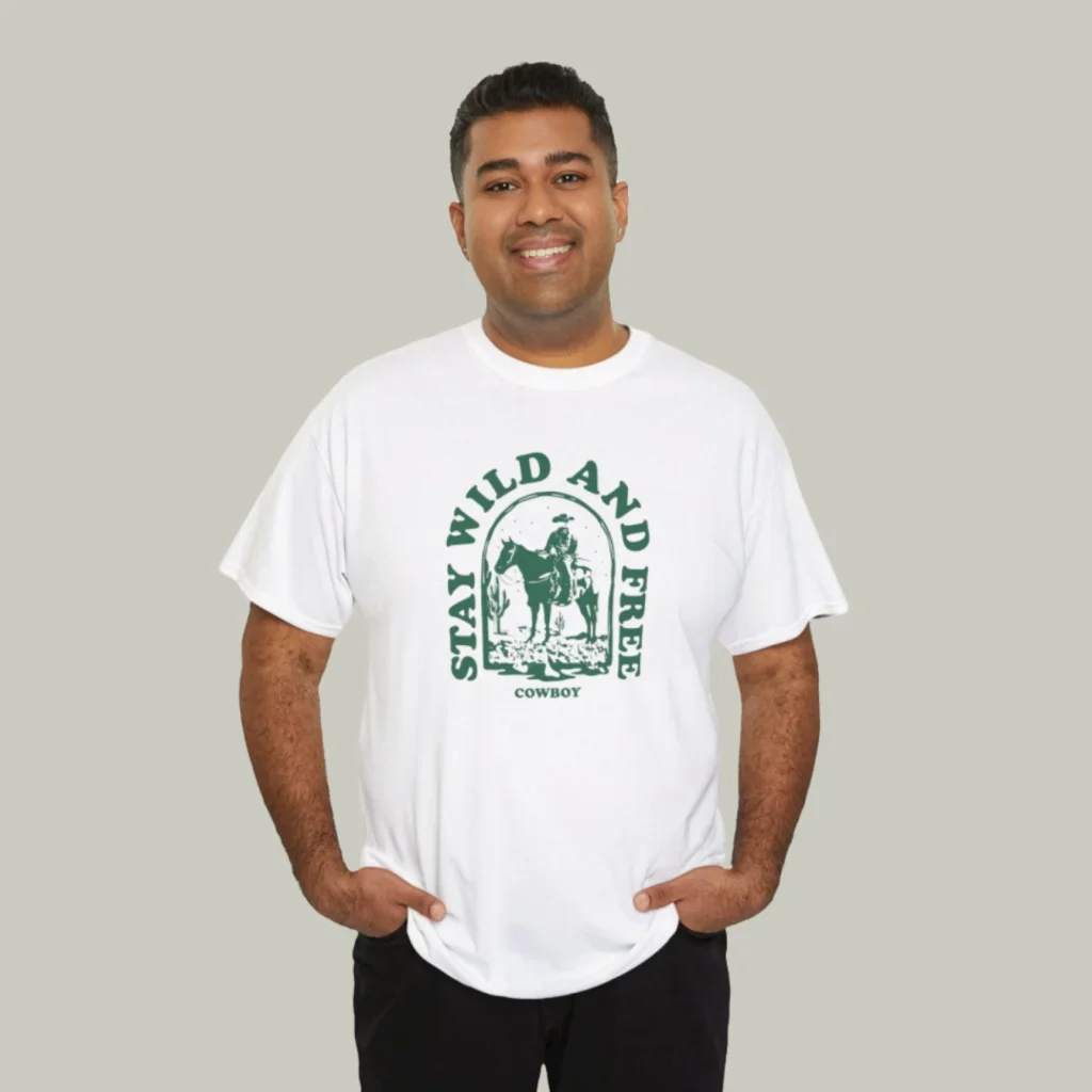 A mockup of a man wearing a t-shirt with a custom “Stay wild and free” print on a light-green background.