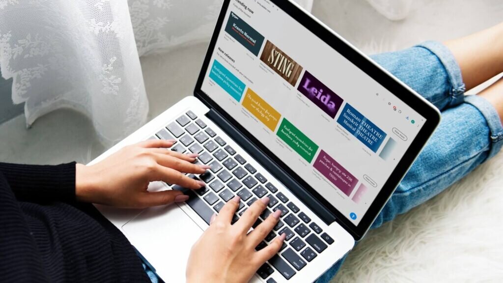 Adobe Fonts homepage on a laptop screen.