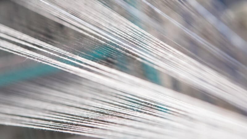 Lines of tightly strung up polyester threads.