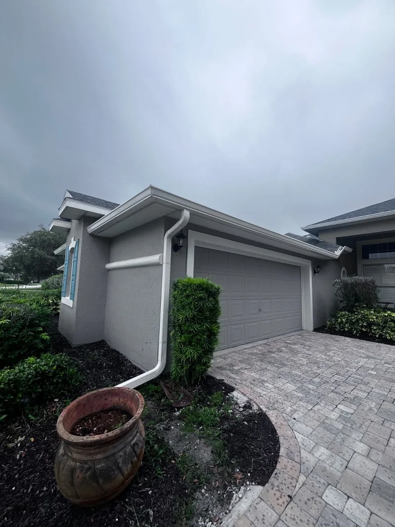 Finished gutter installation around a residential garage