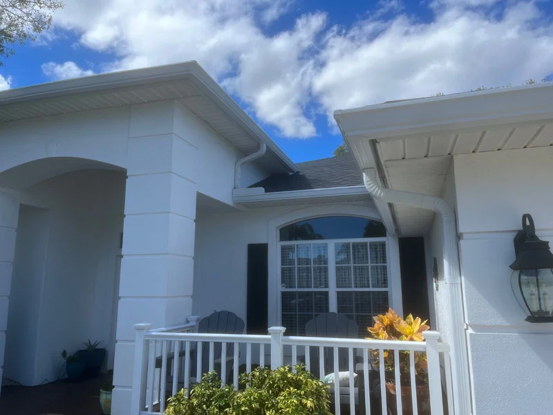 White gutter installation on a covered front porch