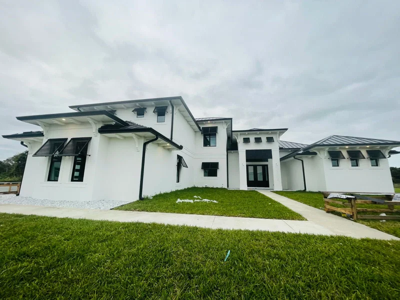 Seamless gutters installed on a white multi-level home