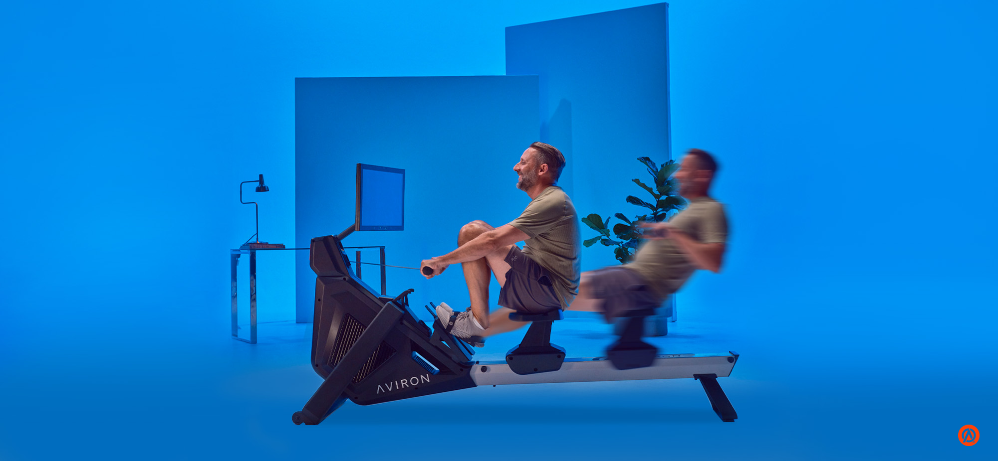 Aviron rower in motion during a rowing workout, showing cardio and strength training benefits.