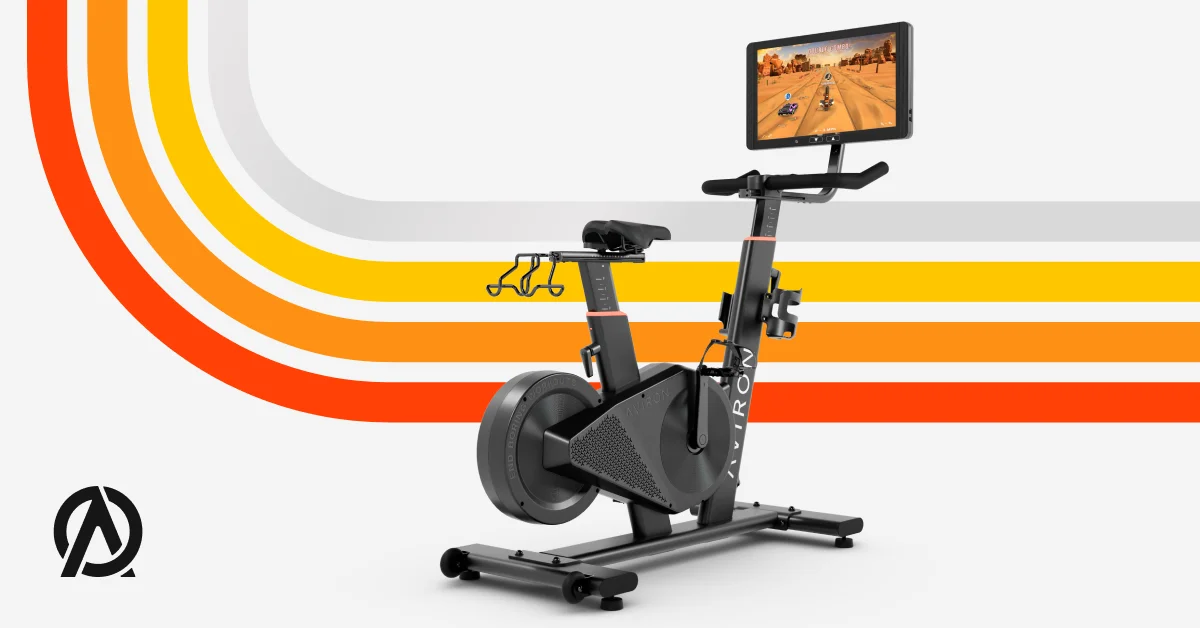 Aviron Fit Bike S with a racing game on the built-in screen, illustrating how workout variety keeps training fun