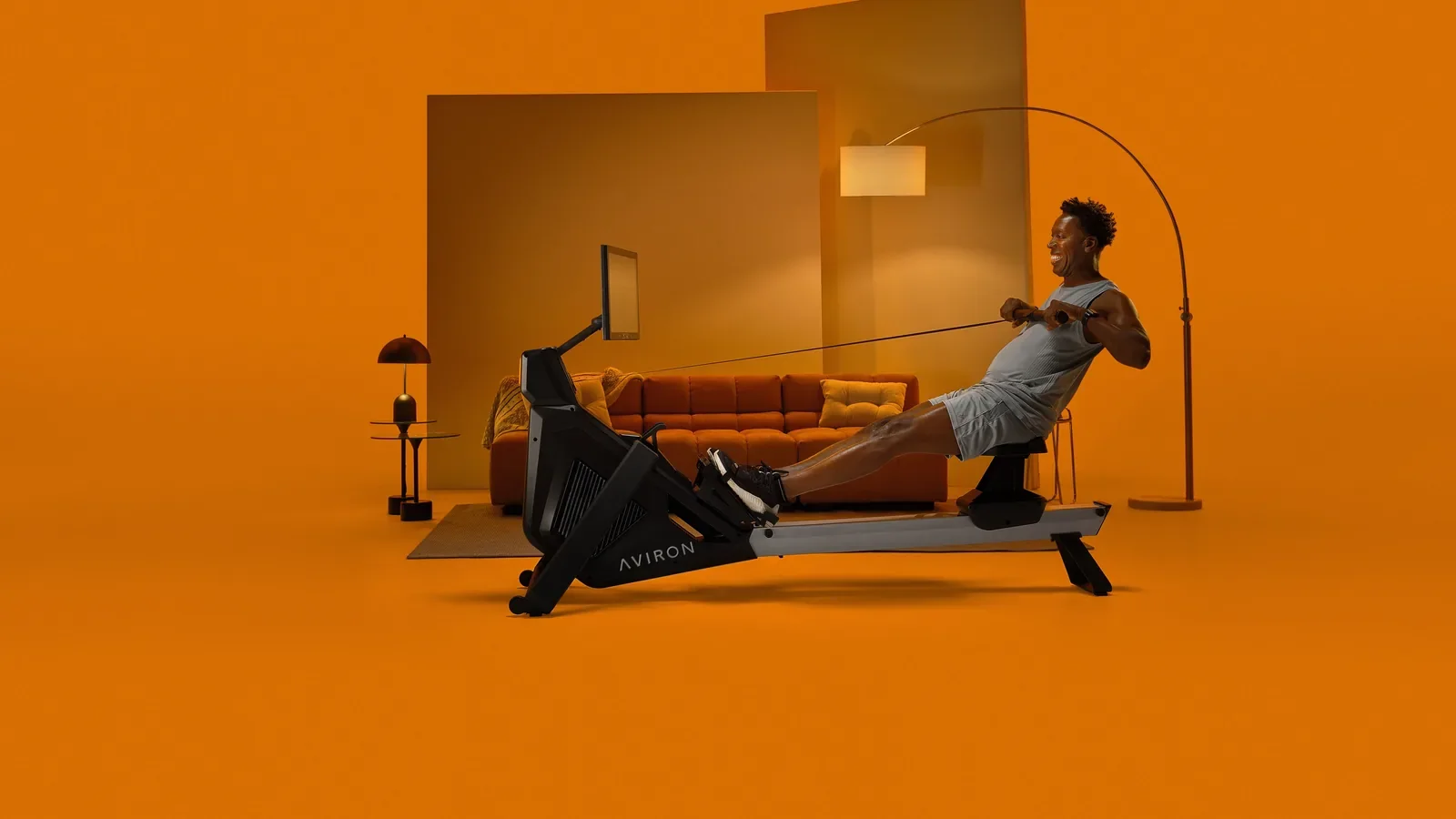 Man rowing at full extension on an Aviron rower
