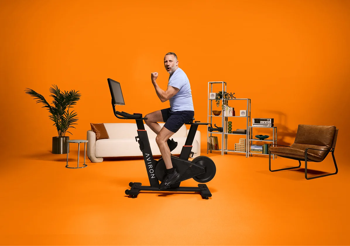 Man building leg strength on an Aviron Fit Bike S stationary bike