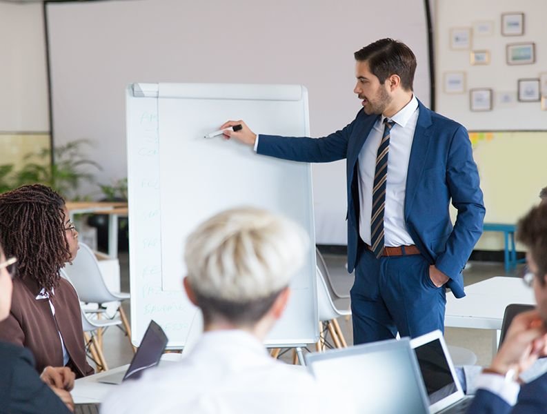 Consultant explaining on a whiteboard