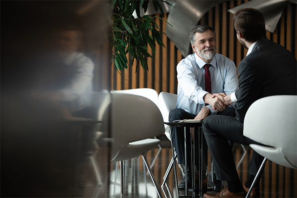 businesspeople shaking hands on finalizing management consulting agreement