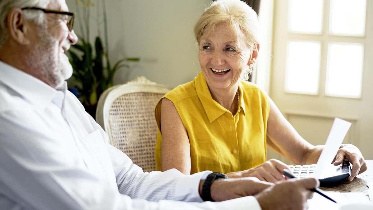 An elderly couple laughing together