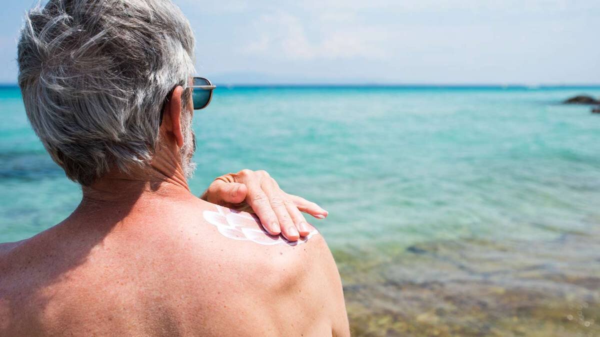 Man Applying sunscreen