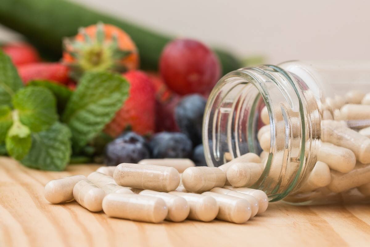 Pills spilling out of a fallen glass jar