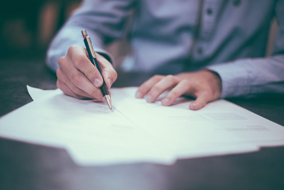 Person taking notes with a pen