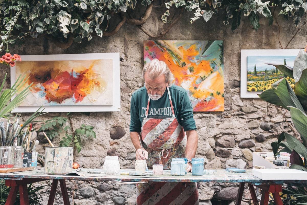 Old artist painting pictures