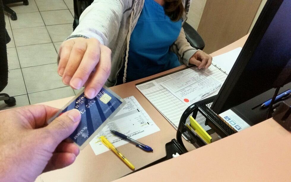 Man handing credit card to employee
