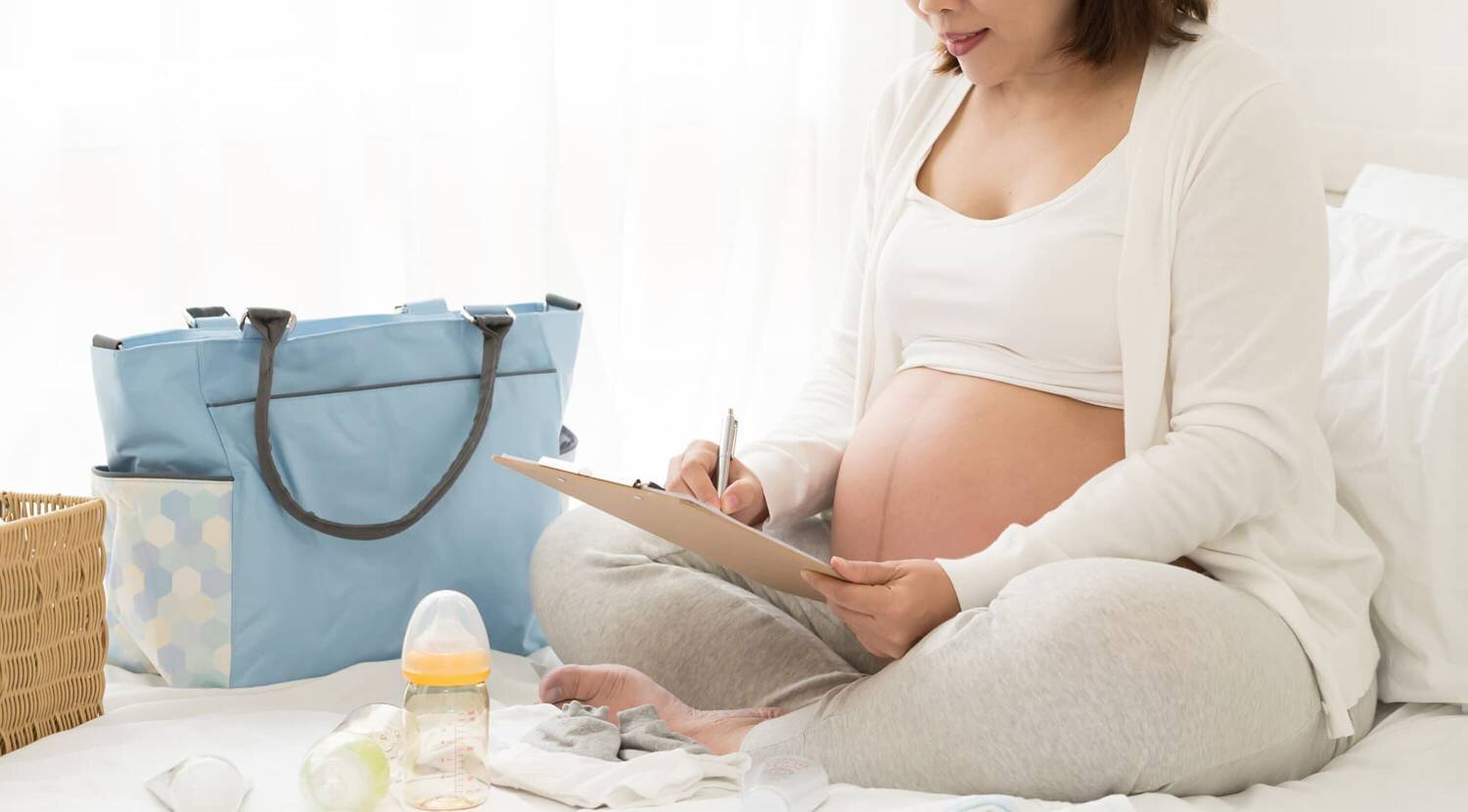 Pregnant woman filling out a form