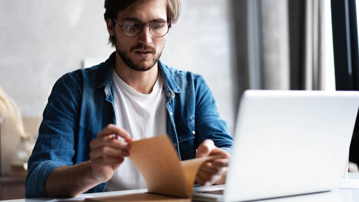 man flipping through notebook