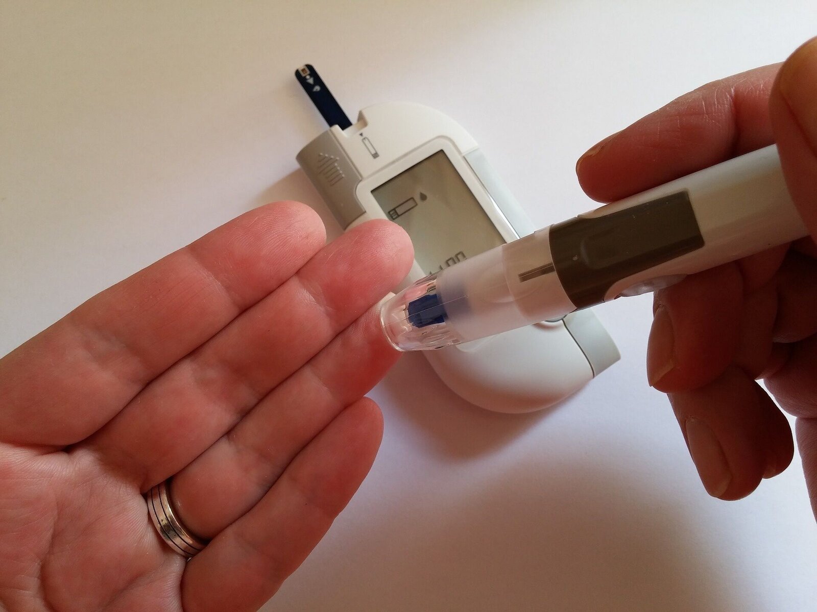 Close-up of a person using a blood glucose meter to check blood sugar levels