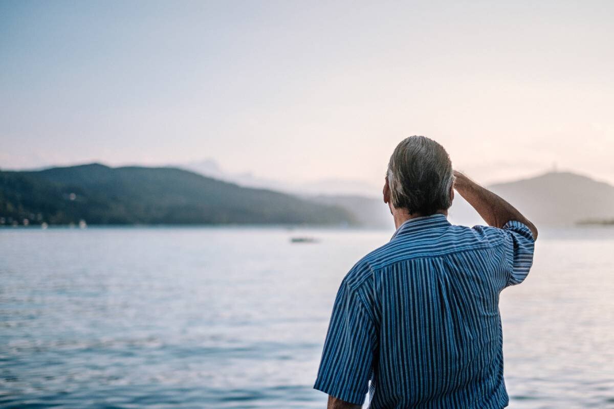 Old man looking at the sea from the shore