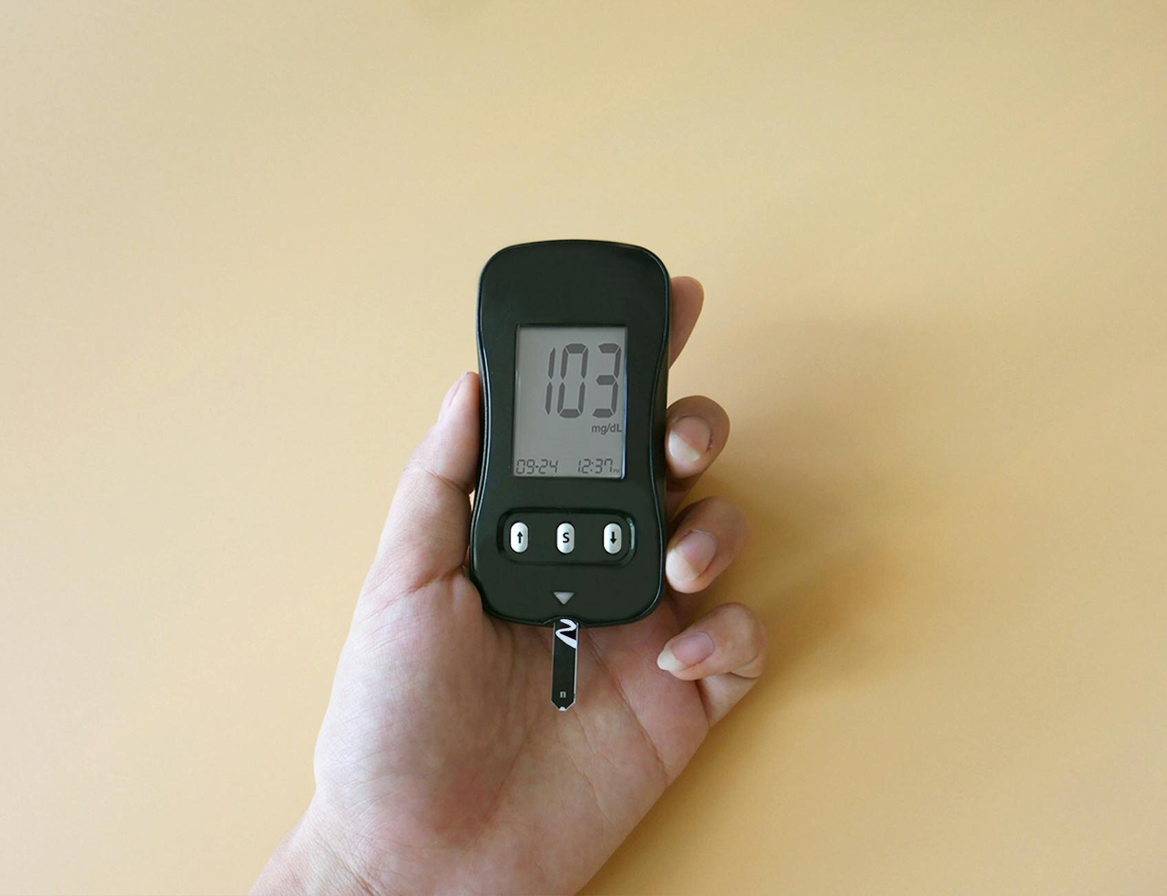 person holding a glucose monitor