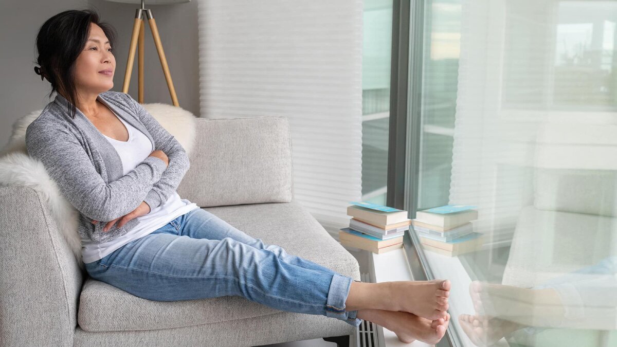 Woman sitting on the sofa looking out of the window