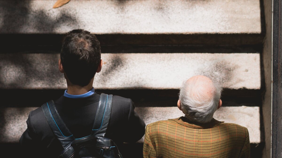 An adult man and an elderly man climbing stairs, with the photo taken from above