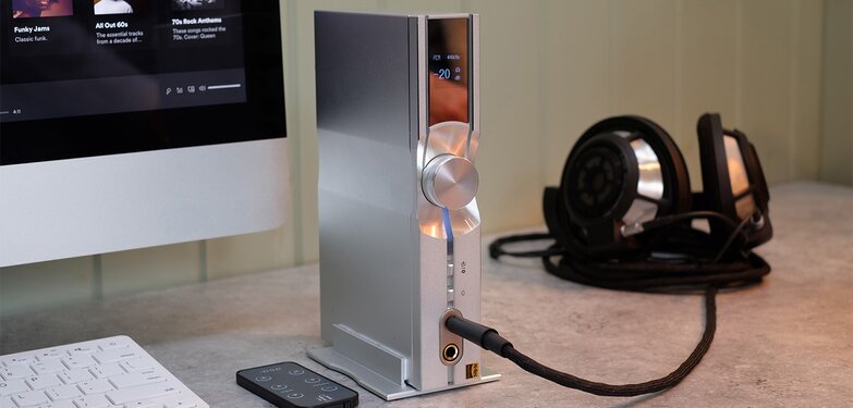 NEO iDSD with headphones plugged in next to the monitor
