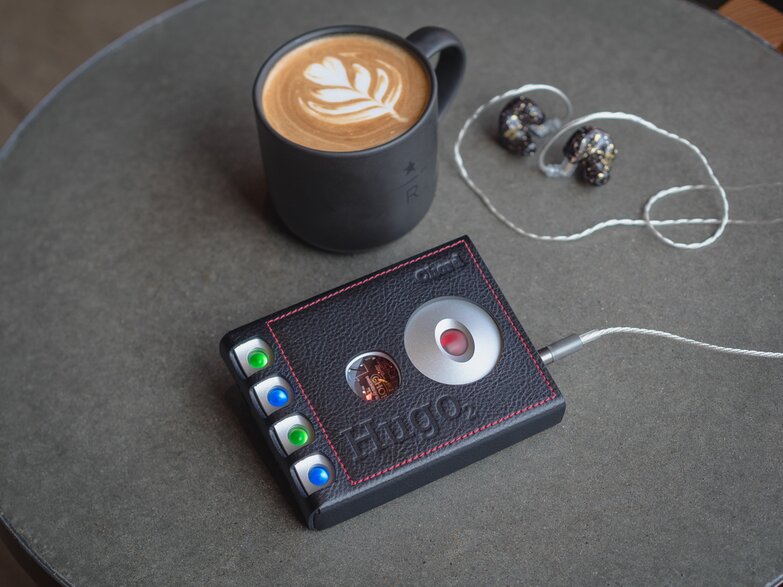 Hugo 2 on the table connected to IEMs next to the coffee