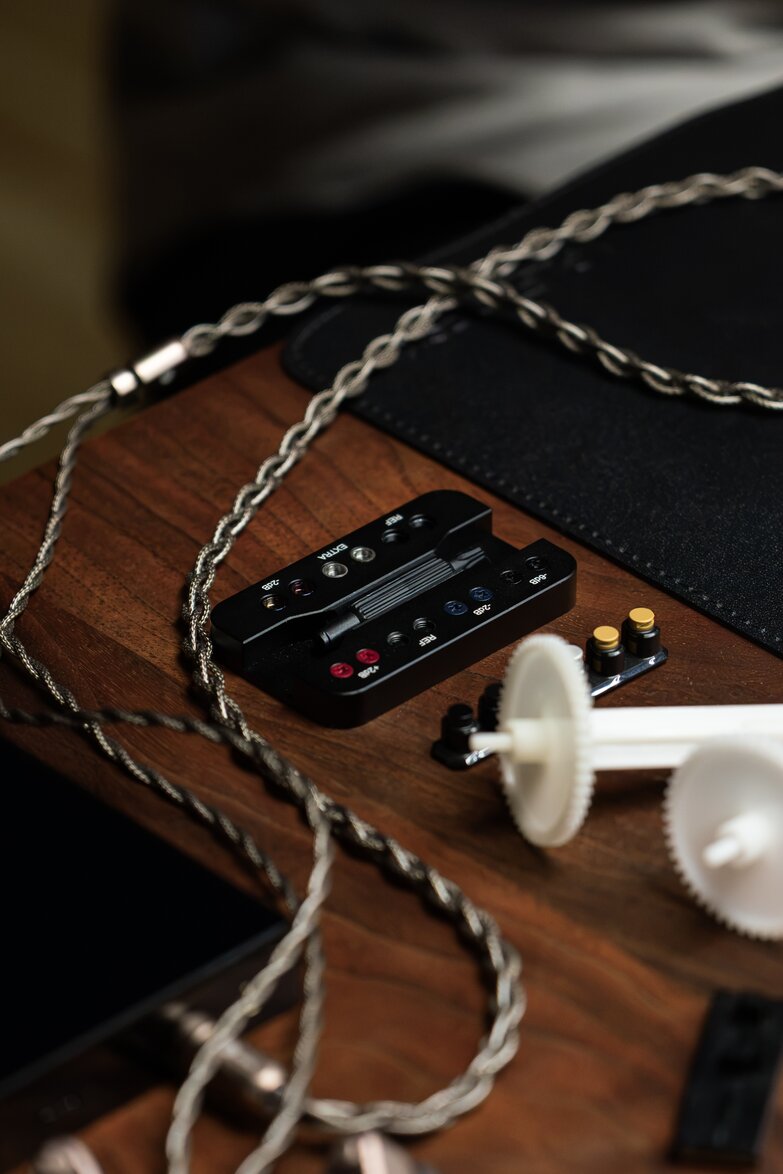 oceam iem braided strand stretching onto a table plugged into phone with tools