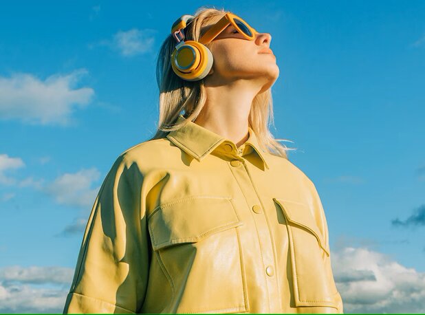 Woman wearing a pair of headphones outside