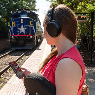 woman wearing Sennheiser Momentum 4 Wireless Headphones