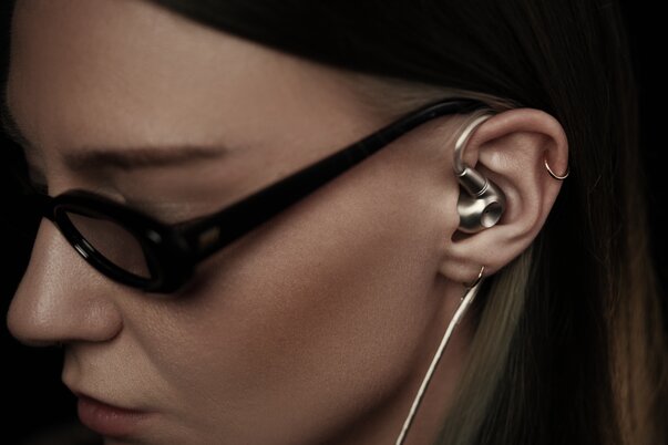 woman with sunglasses on wearing the meze audio ASTRU IEMs in ears