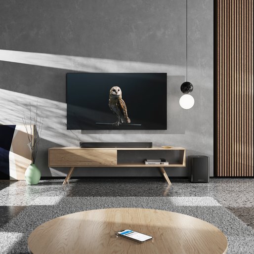 ambeo sub next to sub on table below tv in living room