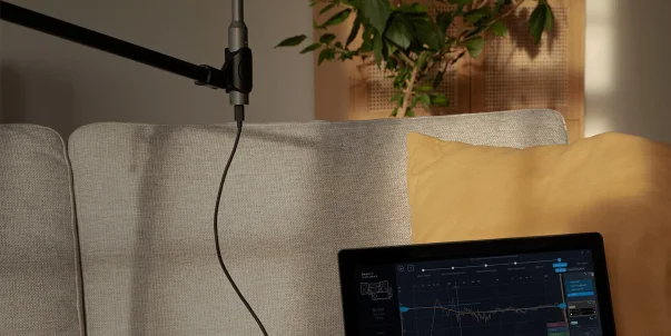 Dirac live measurement mic next to a laptop