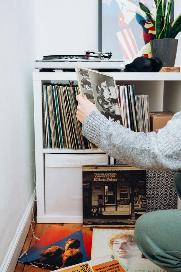 person looking at vinyl record collection