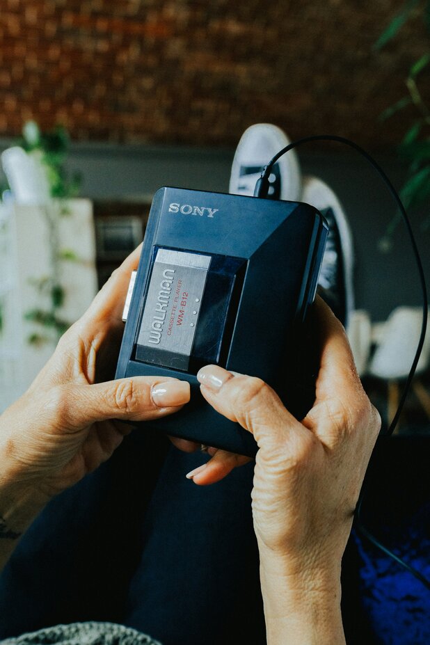 A woman holding the sony walkman music player in her hands