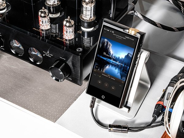 N7 DAP music player by Cayin sitting on a stand next to an amplifier