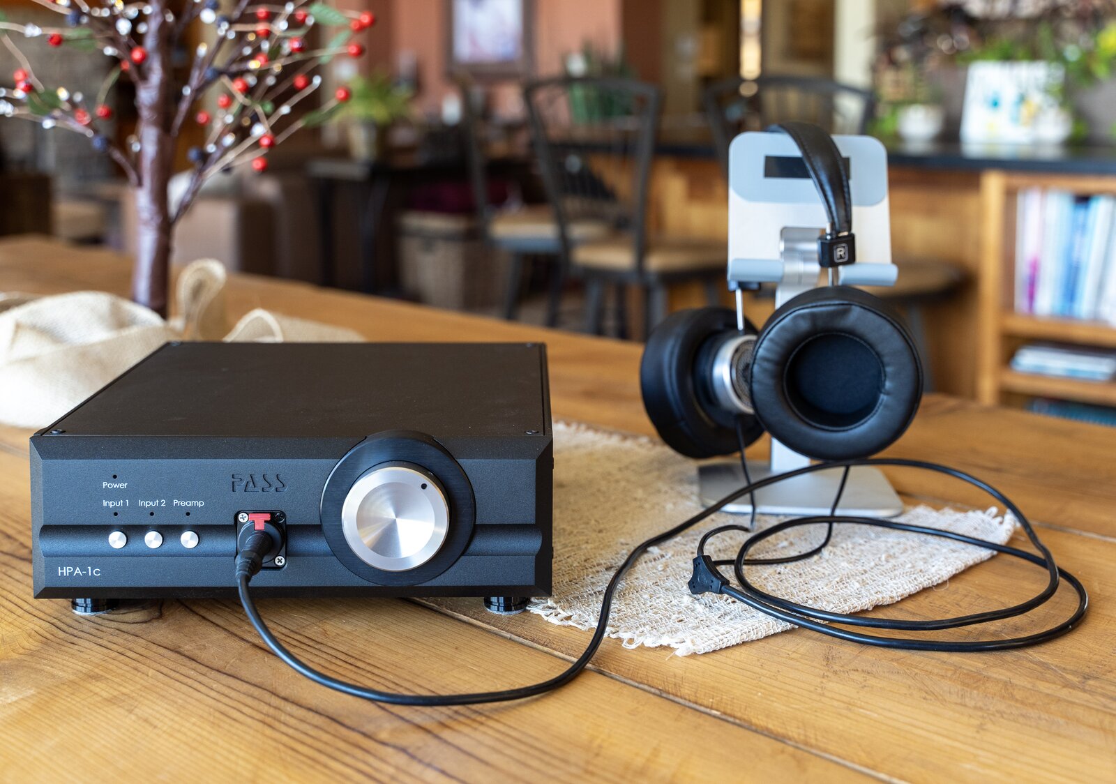 Pass Labs HPA-1C Headphone Amplifier sitting on table with Audeze headphones connected via headphone cable