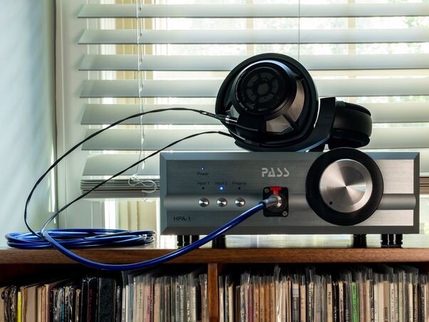 Pass Labs HPA-1 Headphone Amplifier with Sennheiser Headphones on top connected with a blue dragon headphone cable