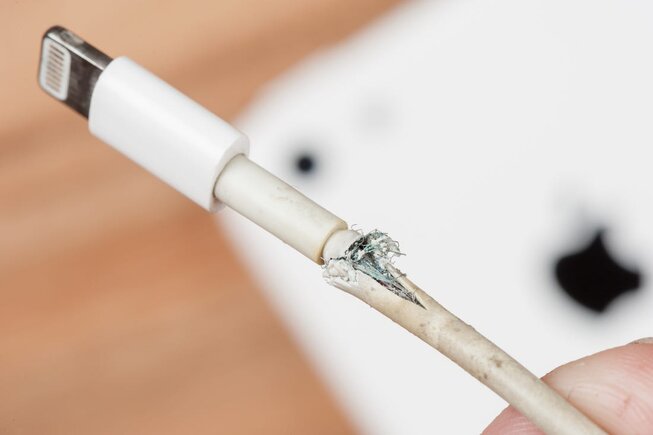 close up shot of a frayed USB lightning cable