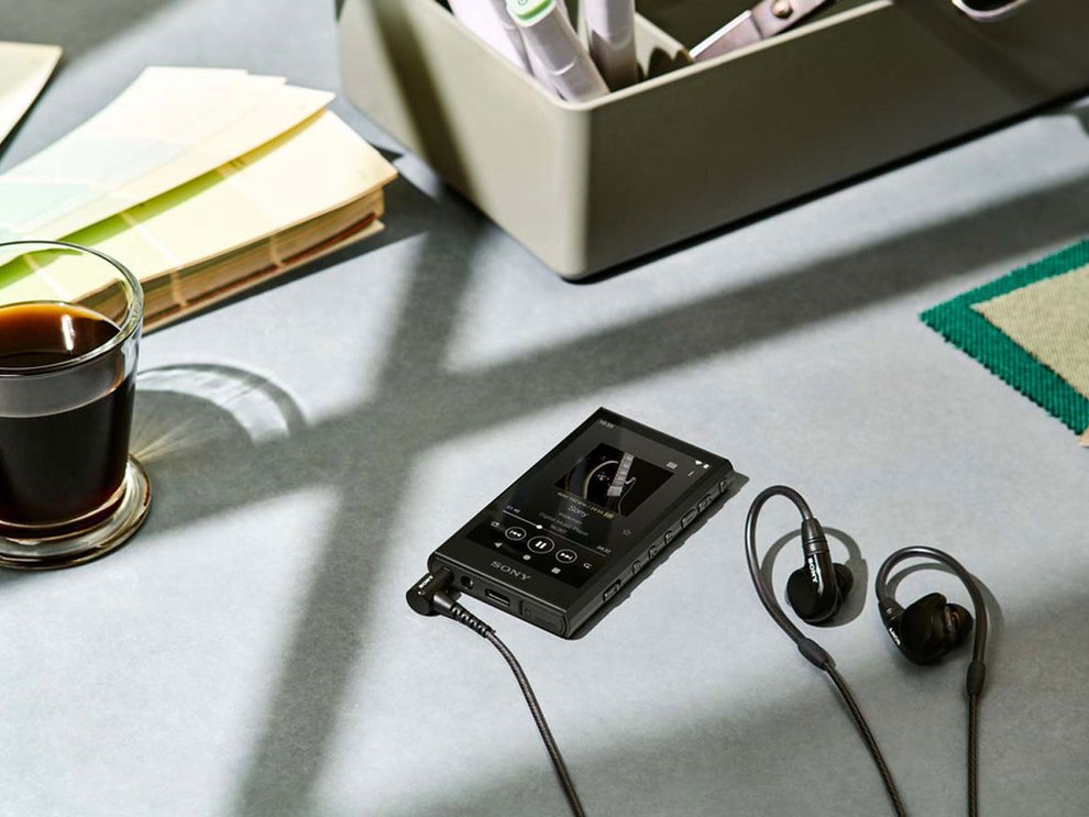 Sony A306 and earbuds on a table
