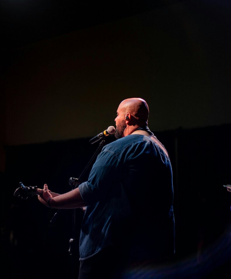 man singing with IEMs