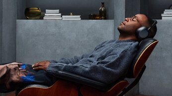 man laying in chair with 1000x on